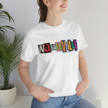 Person wearing a white t-shirt with 'Nashville' in colorful letters, standing against a plain background.